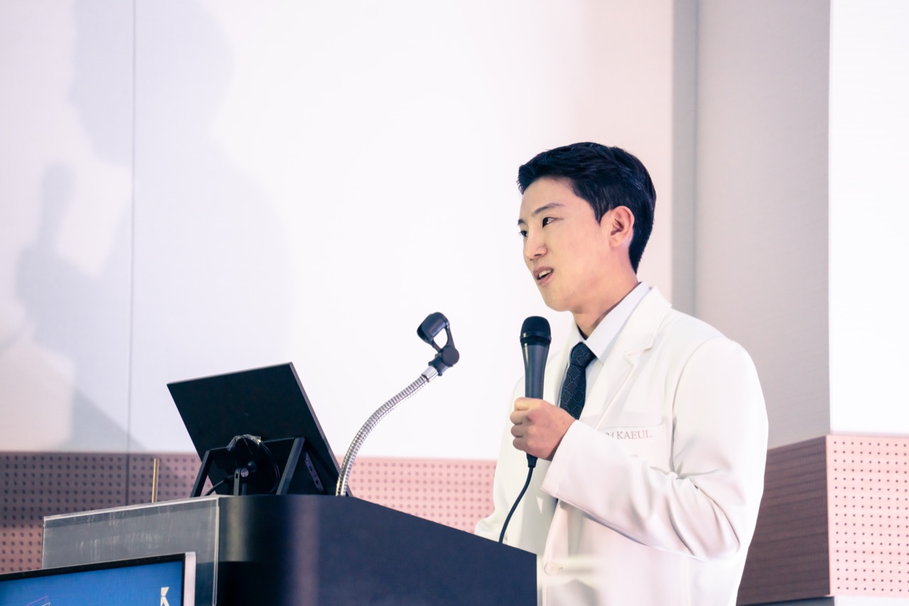 Dr. Daniel Hawon Kim delivering a clinical protocol lecture at an invited medical conference